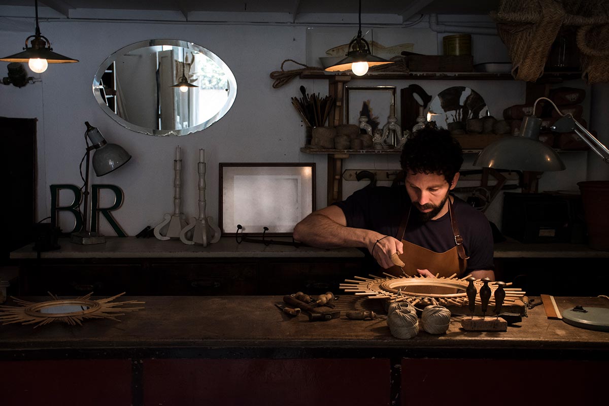 craftsman-manufacturing-a-mirror-in-his-workshop-resize.jpg